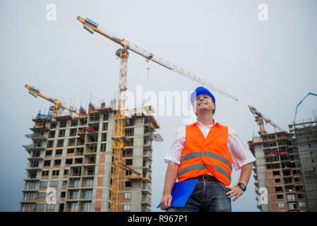 Happy architect on a construction site during a housing project Stock Photo