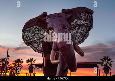 Valencia, Spain - December 15, 2018: Giant wooden and metal elephant at the entrance of the Bioparc zoo in Valencia, Spain, at the time of zoo closing Stock Photo