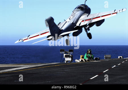 An EA-6B Prowler assigned to the 'Yellowjackets' of Tactical Electronic Warfare Squadron One Three Eight (VAQ-138) takes off from the flight deck as an Aviation Boatswains Mate  prepares to launch the next aircraft aboard the Nimitz- class aircraft carrier USS John C. Stennis (CVN 74). U.S. Navy photo by Mass Communication Specialist 3rd Class Jon Hyde Stock Photo