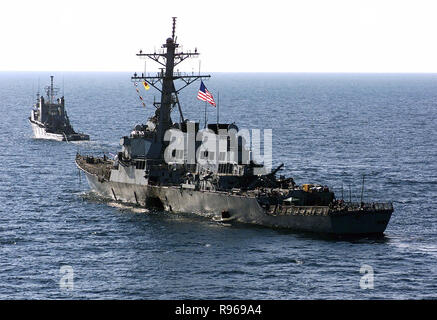 The bomb damaged USS Cole (DDG 67) is towed away from the port city of Aden, Yemen, into open sea by the Military Sealift Command ocean-going tug USNS Catawba on Oct. 29, 2000.  The Arleigh Burke class destroyer was the target of a suspected terrorist attack in the port of Aden on Oct. 12, 2000, during a scheduled refueling.  The attack killed 17 crew members and injured 39 others.   DoD photo by Sgt. Don L. Maes, U.S. Marine Corps Stock Photo