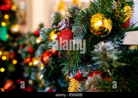 Decorative garland from christmas tree branches and cones. home decorated for winter holidays, little red and gold baubles. Copy space for wishes.Selective focus. Colorful christmas decorations.Happy new year.Home decor. Stock Photo