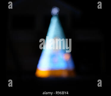 Defocused blue christmas tree on darkness Stock Photo