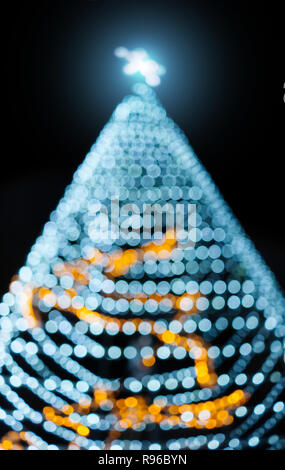 Shining star Christmas tree and bokeh light on night Stock Photo