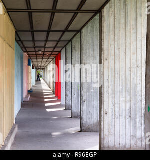 Modern concrete arcade corridor under a huge block of flats in Budapest, Hungary. Several shops line up on the left side, the wall or even the columns Stock Photo