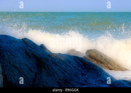 This unique nature picture shows how the sea surf on the beach of Thailand hits a rock and splashes the water. You can still see light and shadow effe Stock Photo