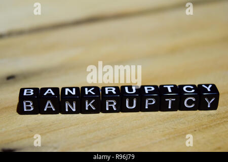 Bankruptcy written on wooden blocks. Inspiration and motivation concepts. Cross processed image on Wooden Background Stock Photo