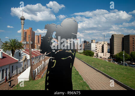 Johannesburg, South Africa, 19 December, 2018. A silhouetted figure keeps guard over the Old Fort on Constitution Hill, as part of a new permanent exhibition there. Using technology such as holograms, the new exhibition additions officially opened in December, telling the stories about prisoners who were housed here, both during the gold rush and later during apartheid. During apartheid, The Old Fort housed white prisoners. Prison guards and soldiers also feature in the exhibition as the Old Fort was a military garrison during the Anglo-Boer War. Credit: Eva-Lotta Jansson Stock Photo