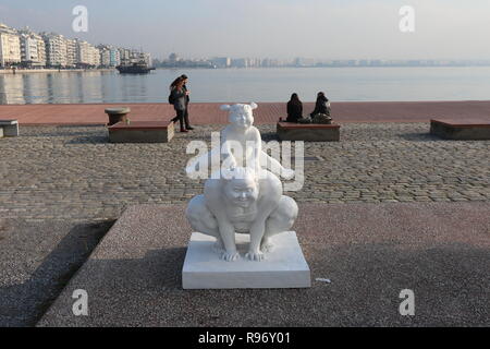 Thessaloniki, Greece, 20'th December 2018.  People walk by and sit next  a statue by Chinese artist Xu Hongfei in the northern Greek port city of Thessaloniki.  Fifteen statues made by Xu Hongfei are exhibited at the waterfront of Thessaloniki between December 17 and December 24, 2018, as part of artist's worldwide sculpture exhibition, which begins in Thessaloniki. Credit : Orhan Tsolak / Alamy Live News Stock Photo