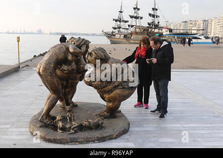 Thessaloniki, Greece, 20'th December 2018.  People look at a statue by Chinese artist Xu Hongfei in the northern Greek port city of Thessaloniki.  Fifteen statues made by Xu Hongfei are exhibited at the waterfront of Thessaloniki between December 17 and December 24, 2018, as part of artist's worldwide sculpture exhibition, which begins in Thessaloniki. Credit : Orhan Tsolak / Alamy Live News Stock Photo