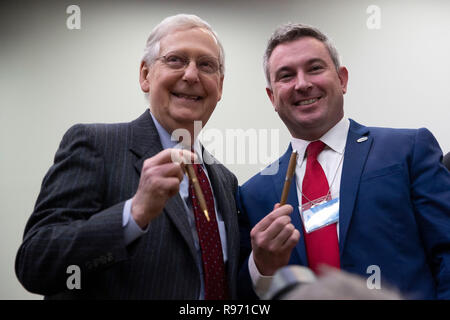 Washington, United States Of America. 20th Dec, 2018. Senate Majority Leader Mitch McConnell, Republican of Kentucky, left, and Commissioner of Agriculture of the state of Kentucky, Ryan Quarles, hold up hemp pens prior to a bill signing ceremony for the signing of the Farm Bill at the White House in Washington, DC on December 20, 2018. Credit: Alex Edelman/CNP | usage worldwide Credit: dpa/Alamy Live News Stock Photo