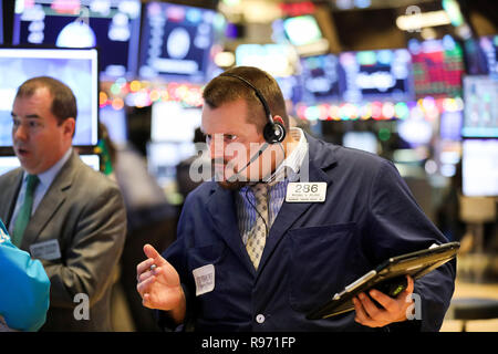 New York, USA. 20th Dec, 2018. Traders work at the New York Stock Exchange in New York, the United States, Dec. 20, 2018. U.S. stocks closed lower on Thursday as investors digested the central bank's latest rate hike decision. The Dow Jones Industrial Average was down 464.06 points, or 1.99 percent, to 22,859.60. The S&P 500 fell 39.54 points, or 1.58 percent, to 2,467.42. The Nasdaq Composite Index fell 108.42 points, or 1.63 percent, to 6,528.41. Credit: Wang Ying/Xinhua/Alamy Live News Stock Photo