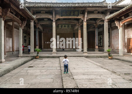 Small boy standing in Dun Ben Tang (Ancestral Hall for Men) Tangyue, China Stock Photo