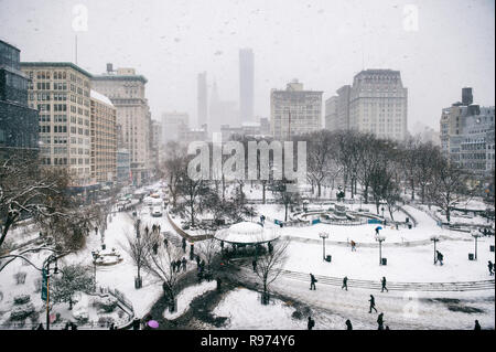 Snowy winter scene with trails left by pedestrians in the snow in Union Square as a blizzard overtakes New York City