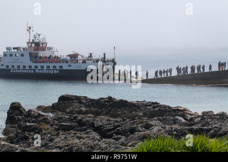 Caledonian MacBrayne Ferry. First-foot passengers of the day, arriving from Fionnphort, Mull, disembarking Quayside St. Ronan’s Bay, Isle of Iona. The Inner Hebrides. Argyll and Bute, West Coast of Scotland. The UK. Stock Photo