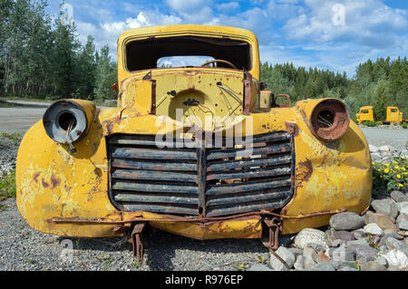 The front of an abandoned old yellow truck Stock Photo