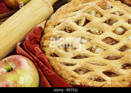 Delicious fresh baked apple pie with rolling pin and ingredients. Perfect for the holidays. Stock Photo