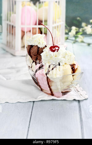 Banana split with neapolitan ice cream, whipped cream and cherry. Stock Photo