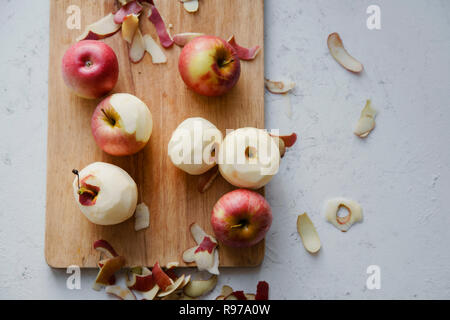 Peeling red apples for cooking an apple pie Stock Photo
