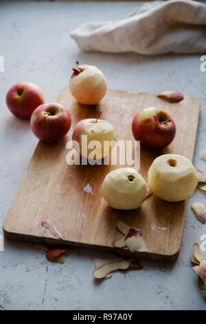 Peeling red apples for cooking an apple pie Stock Photo