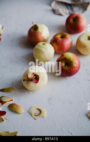 Peeling red apples for cooking an apple pie Stock Photo