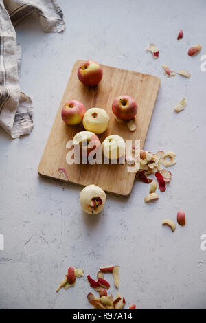 Peeling red apples for cooking an apple pie Stock Photo