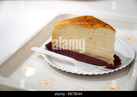 The delicious crepe cake served on the paper plate. Stock Photo