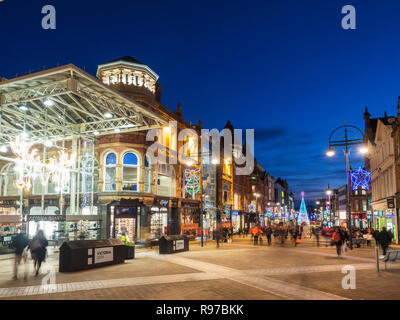 Victoria Quarter and Briggate shopping street busy at dusk at Chrsitmas in Leeds West Yorkshire England Stock Photo