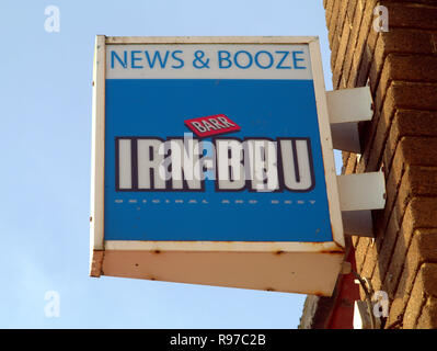 newsagent advertising sign for irn bru irn-bru for a shop called news and booze blue sky Stock Photo