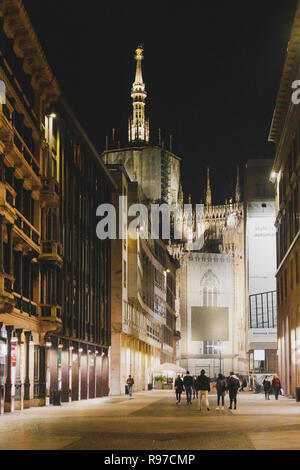 MILANO, ITALY - December 4th, 2018: Corso Vittorio Emanuele one of Milan's main shopping streets by night with the Duomo Cathedral in the distance Stock Photo
