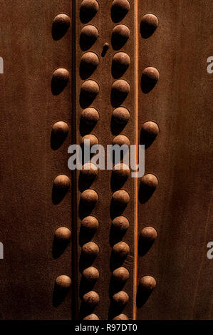 Rivets close-up along metal storage tank creating a design element Stock Photo