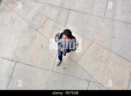 Looking down from high angle on one pedestrian walking Stock Photo