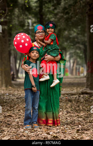 DHAKA, BANGLADESH - DECEMBER 16 : A mother wth her child poses for photograph during the Victory Day celebrations in Dhakain Dhaka, Bangladesh on Dece Stock Photo