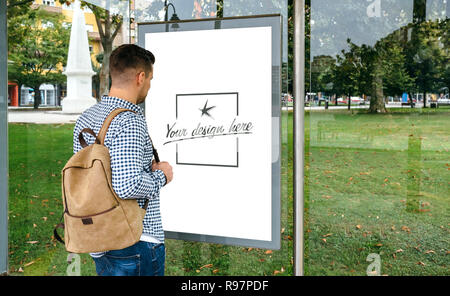 Man from looking at bus marquee poster Stock Photo