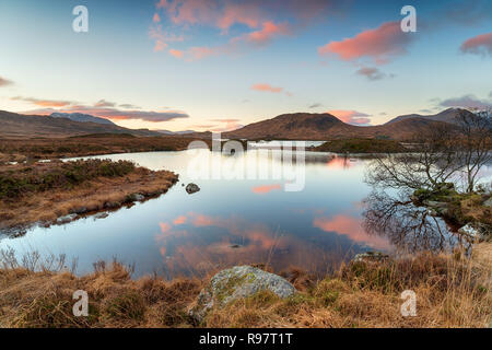 Sunrise over Lochan na h Achlaise on Rannoch Moor at Glencoe in the Scottish Highlannds Stock Photo