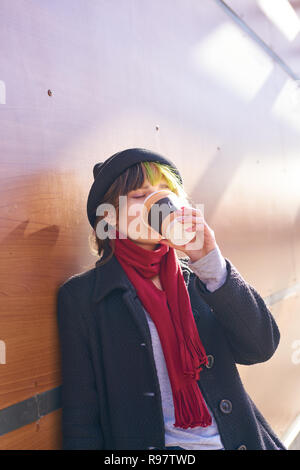 KALININGRAD, RUSSIA - CIRCA APRIL, 2018: young woman drinks a coffee from a McDonald's restaurant in Kaliningrad. Stock Photo