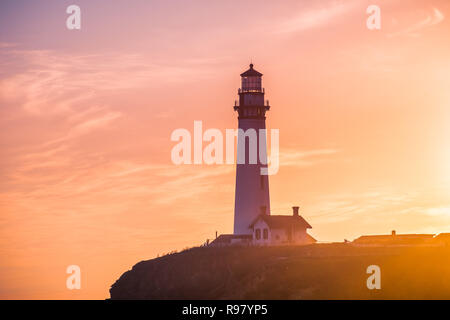 Pigeon Point Lighthouse historical building bathed in sunset light; Pacific Ocean coastline, Pescadero, California Stock Photo