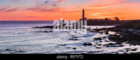 Rocky shoreline close to the Pigeon Point Lighthouse on the Pacific Ocean coastline; beautiful colorful sunset landscape; Pescadero, San Francisco bay Stock Photo