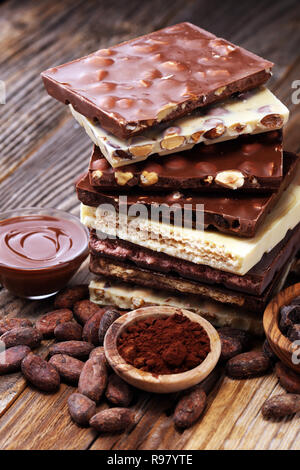 Chocolate bars on table with chocolate tower. Chocolate and nuts Stock Photo