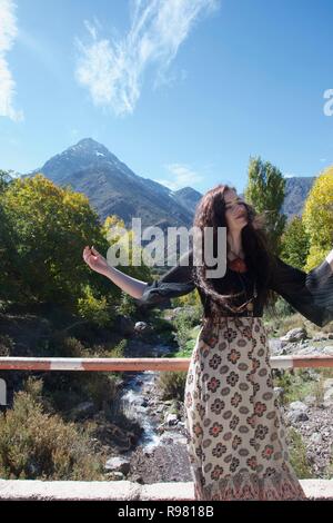 Hippie long haired western female tourist posing in a beautiful valley in the foothills of the Atlas Mountains Stock Photo