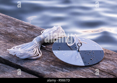 Secchi disk with rope prepared for water transparency measurement Stock ...