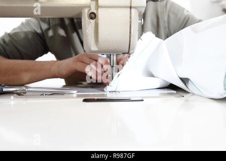 woman hands sewing machine, close up Stock Photo
