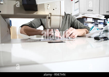 woman hands sewing machine, close up Stock Photo
