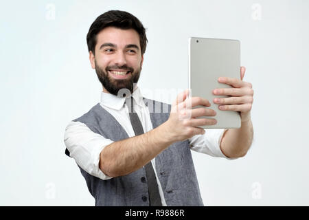 Man talking to family via video chat during vwork Stock Photo