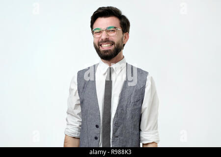 Young handsome business man over isolated background happy face smiling and looking at the camera. Stock Photo