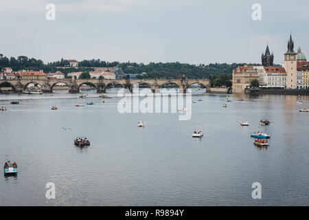 Prague, Czech Republic - August 23, 2018: Panoramic view of paddle boats on Vltava river in Prague, Charles Bridge on the background. Vltava is the lo Stock Photo