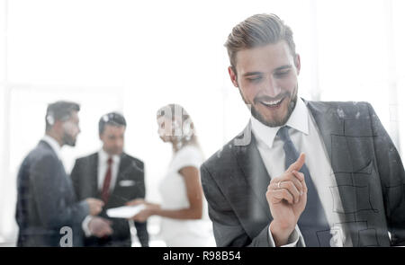 successful businessman touching his finger to the glass Board. Stock Photo