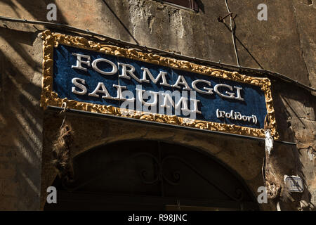 Rather ornate 'Formaggi Salumi' sign over Italian butcher shop (delicatessen enoteca) - cheese and salami, ham etc. Stock Photo