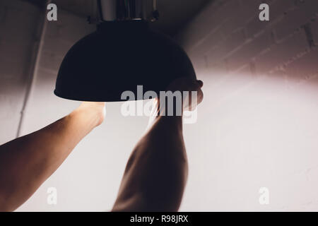 Hands changing with new LED lamp light bulb,Power saving concept. Stock Photo