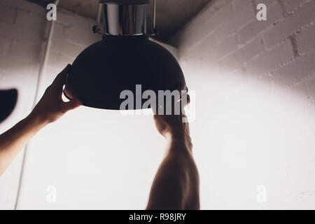Hands changing with new LED lamp light bulb,Power saving concept. Stock Photo