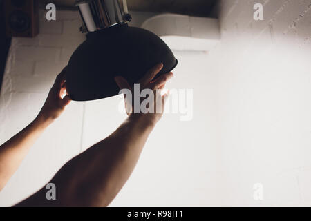Hands changing with new LED lamp light bulb,Power saving concept. Stock Photo